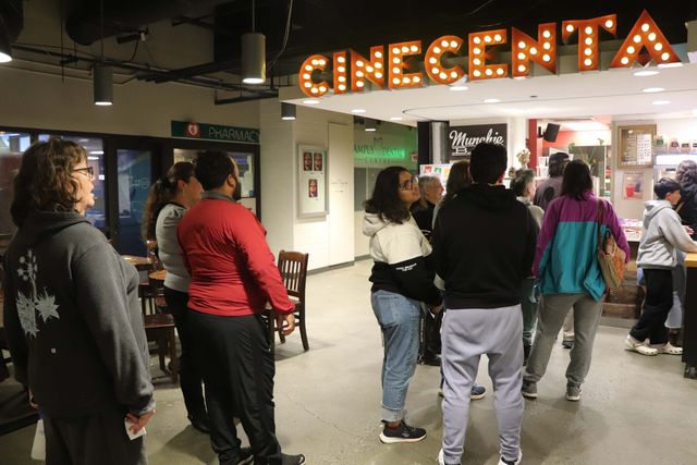 People queuing and talking in the Cinecenta lobby before a screening